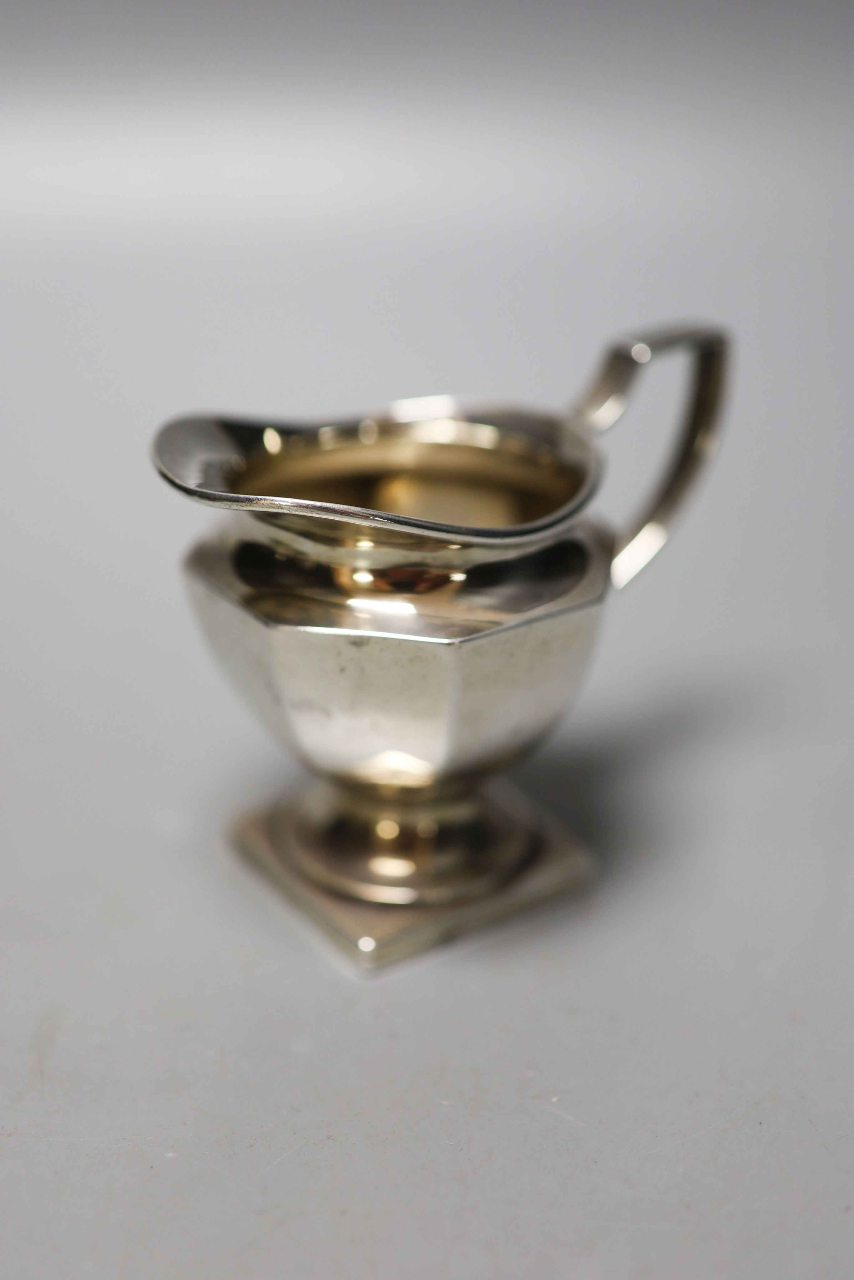 A pair of Victorian silver bun salts, London, 1859, two silver spoons, two mounted whisky tot jug (one a.f.), a silver cream jug, a silver napkin ring and a silver two handled pot and cover.